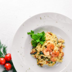 Risotto with shrimp. On a wooden background. Top view. Free space for your text.
